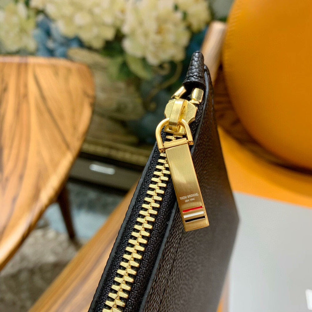 Three-color woven clutch bag
