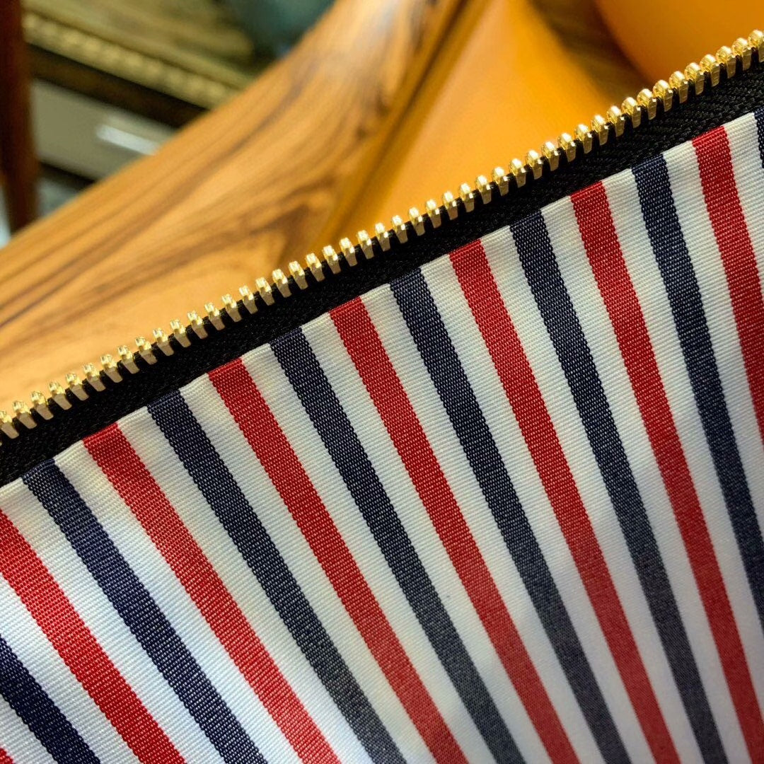 Three-color woven clutch bag